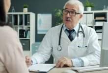 A calm conversation between a fertility specialist and a patient across a desk in a bright consultation room