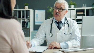 A calm conversation between a fertility specialist and a patient across a desk in a bright consultation room